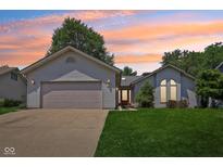 Charming single-story home featuring a two-car garage and manicured lawn at 430 Oakbrook Dr, Columbus, IN 47201