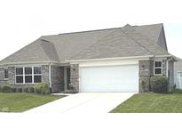Charming brick home featuring a two-car garage and a well-maintained lawn, offering great curb appeal at 4420 Wild Turkey Dr, Indianapolis, IN 46239