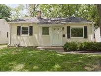 Charming home showcasing a quaint front yard and inviting facade with neat landscaping at 5636 Crittenden Ave, Indianapolis, IN 46220