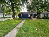 Charming single-story home with a well-maintained lawn and inviting front porch at 5704 N Keystone Ave, Indianapolis, IN 46220