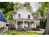 Charming two-story home featuring a covered front porch and well-maintained landscaping at 5919 Central Ave, Indianapolis, IN 46220