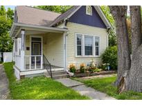 Charming single-Gathering home featuring a cozy front porch, well-maintained yard, and a blend of classic architectural details at 602 Prospect St, Indianapolis, IN 46203