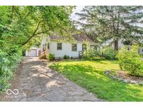 Charming home featuring a well-maintained lawn, mature trees, and a quaint design at 6235 N Temple Ave, Indianapolis, IN 46220