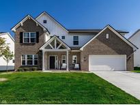 Charming two-story home with brick and siding, well-manicured lawn, and a two-car garage at 628 Tess Blvd, Westfield, IN 46074
