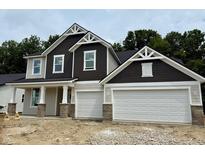 Two-story home featuring a two-car garage and stylish architectural detailing at 8356 Leander Ave, Zionsville, IN 46077