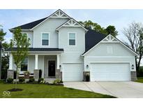 Charming two-story home featuring a manicured lawn, inviting front porch, and a convenient two-car garage at 8356 Leander Ave, Zionsville, IN 46077