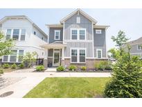 Charming two-story home with manicured front yard, lush green lawn, and inviting walkway at 9248 Hawley Dr, Indianapolis, IN 46216