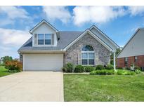 Charming single-Gathering home featuring a brick facade, attached garage, and well-manicured lawn at 10712 Cardinal Cir, Indianapolis, IN 46231