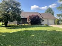 Ranch-style home with large front yard, mature tree, and a two-car garage at 1082 E County Road 400 S, Clayton, IN 46118