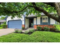 Charming single Gathering home featuring an attached garage and mature landscaping in a suburban neighborhood at 11518 Cherry Blossom W Dr, Fishers, IN 46038