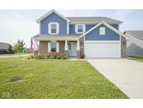 Charming two-story home featuring a well-manicured lawn and a two-car garage at 1278 W Limestone Way, Fortville, IN 46040