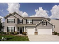 Charming two-story home features a well-maintained lawn and a two-car garage at 1312 Donald Pass, Greenwood, IN 46143