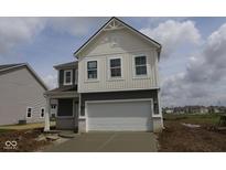 Charming two-story home with gray and white siding and a two-car garage on a sunny day at 1890 Victor Higgins Dr, Shelbyville, IN 46176