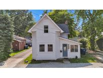 Charming two-story home featuring a tidy front yard, classic architectural details, and a welcoming blue front door at 247 N 14Th St, Noblesville, IN 46060
