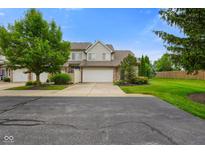 Charming townhome featuring a two-car garage, inviting curb appeal and manicured landscaping in a beautiful community at 255 Bastion Pl # Apt D, Avon, IN 46123