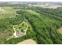 Stunning aerial view of a secluded home surrounded by lush greenery and a winding driveway at 2825 E 216Th St, Cicero, IN 46034