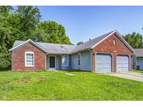 Charming single-story home featuring a brick facade, attached two-car garage, and well-maintained lawn at 3816 Cologne Ct, Indianapolis, IN 46228