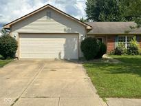 Ranch home featuring a two car garage, neutral siding, and brick accents at 39 Meadow Creek East Blvd, Whiteland, IN 46184