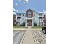 Charming condo building with brick and siding, featuring a well-maintained lawn and convenient parking at 5019 Amber Creek Pl, Indianapolis, IN 46237