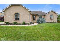 Charming brick home featuring arched windows and professionally landscaped front yard at 5274 Brooks Bnd, Greenwood, IN 46143