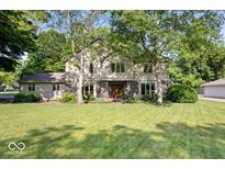 Charming two-story home with brick accents, large front yard, and mature trees at 54 Horseshoe Ln, Carmel, IN 46033