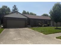 Charming brick home with attached garage, well-kept lawn, and mature shade trees at 613 Monte Vista Dr, Greenwood, IN 46143