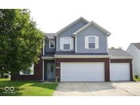 Charming two-story home featuring a brick and vinyl exterior with a two-car garage and well-maintained lawn at 6563 Enclave Blvd, Greenwood, IN 46143