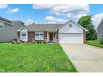 Charming one-story home featuring a manicured lawn, brick facade, and an attached two car garage at 8038 Sydney Ln, Avon, IN 46123