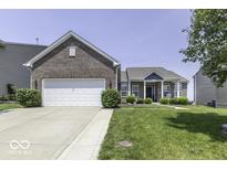 Charming brick home featuring a well-manicured lawn and a spacious two-car garage, perfect for suburban living at 8864 S Tibbs Ave, Indianapolis, IN 46217
