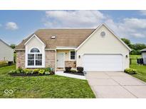 Charming single-Gathering home featuring a well-manicured lawn and a two-car garage at 11320 Lynchburg Way, Indianapolis, IN 46229