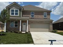 Two-story home featuring a manicured lawn, brick facade, attached two-car garage, and welcoming entrance at 1326 Foxtail Ln, Greenwood, IN 46143