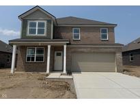 Two-story brick home featuring a two-car garage, covered entry, and well-maintained landscaping at 1326 Foxtail Ln, Greenwood, IN 46143