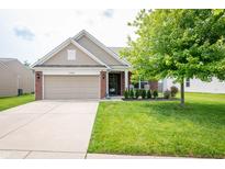 Charming single-Gathering home featuring a well-manicured lawn, two-car garage, and inviting curb appeal at 1792 Persimmon Grove Dr, Indianapolis, IN 46234
