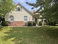 Charming two-story home featuring a well-maintained lawn and brick accents near the foundation at 19409 Mimosa Ct, Noblesville, IN 46060