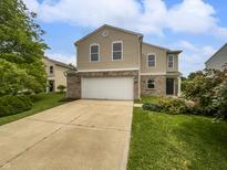 Inviting two-story home featuring a two car garage, brick accents, and manicured lawn at 3445 Brandenburg Blvd, Indianapolis, IN 46239