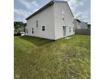 Spacious backyard featuring a well-maintained lawn, perfect for outdoor activities and relaxation at 4264 Village Trace Dr, Indianapolis, IN 46254