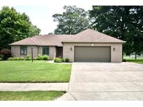 Charming brick home with a well-maintained lawn and inviting curb appeal in a tranquil neighborhood at 5943 Red Maple Dr, Indianapolis, IN 46237