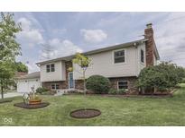 Charming home featuring a brick chimney, complemented by a well-manicured lawn and landscaping at 617 Echo Bend Blvd, Greenwood, IN 46142