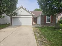 Charming single-story home with a two-car garage, brick accents, and well-maintained landscaping at 7307 Barnwell Pl, Indianapolis, IN 46217