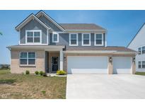 Charming two-story home with a three-car garage and well-maintained front yard at 7510 Hillway Dr, Camby, IN 46113