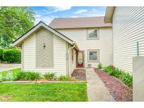 Inviting home exterior with a well-manicured lawn and a charming red front door at 7724 Eagle Valley Pass, Indianapolis, IN 46214