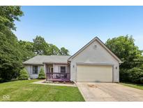 Charming one-story home featuring a well-maintained lawn and attached two-car garage at 7831 Bayridge Dr, Indianapolis, IN 46236