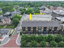A picturesque aerial view of a townhome complex with modern architecture and rooftop terraces at 80 Monon Blvd, Carmel, IN 46032