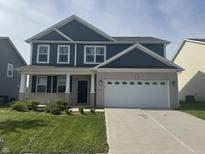 Charming two-story home featuring a brick facade, blue siding, and a well-maintained front lawn at 8969 Faulkner Dr, Indianapolis, IN 46239