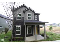 Charming two-story home showcasing gray siding, a covered porch, and a vibrant yellow front door at 9516 Bauhaus Way, Indianapolis, IN 46240
