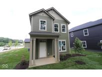 Charming two-story home with a covered porch, green siding, and a well-manicured lawn at 9520 Bauhaus Way, Indianapolis, IN 46240