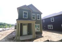 Two-story home featuring a covered porch, double-hung windows, and stylish green siding at 9520 Bauhaus Way, Indianapolis, IN 46240