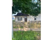 Quaint home featuring a rustic, wooden fence and a well-maintained lawn at 1006 Hurricane St, Franklin, IN 46131