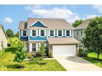Charming two-story home featuring blue accents, white shutters, well-manicured lawn, and an attached two-car garage at 1314 Old Heritage Pl, Greenwood, IN 46143