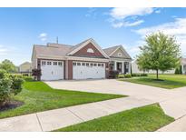 Charming brick home with a well-manicured lawn, attached two-car garage, and inviting curb appeal at 13327 Hockley Dr, Fishers, IN 46037